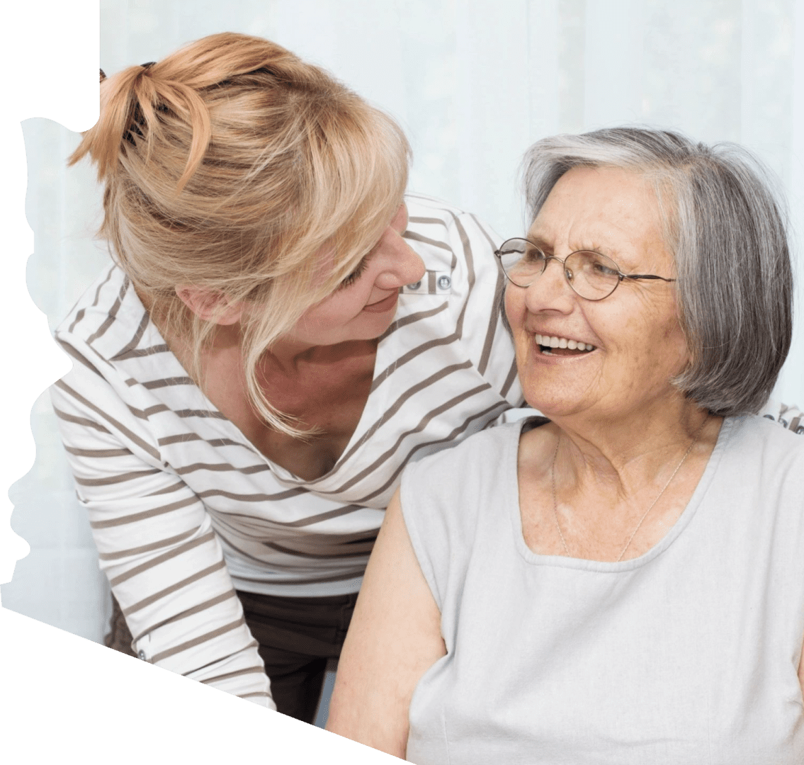 A woman and an older person smiling for the camera.